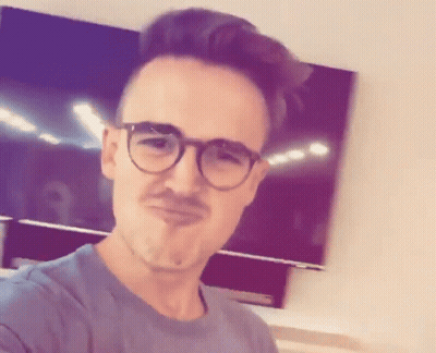 A Man With Glasses And A Mustache Is Making A Face GIF