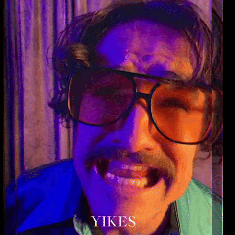 A Man With Glasses And A Mustache Is Making A Funny Face And The Word Yikes Is On The Bottom GIF