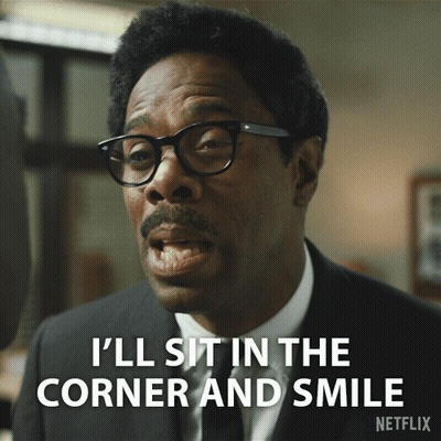A Man With Glasses And A Mustache Is Saying I 'Ll Sit In The Corner And Smile GIF