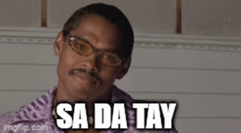 A Man With Glasses And A Mustache Is Saying Sa Da Tay . GIF