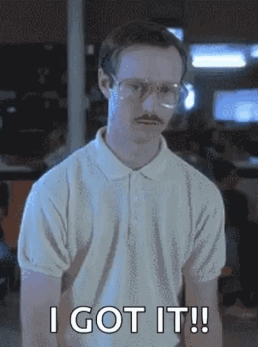 A Man With Glasses And A Mustache Is Standing In A Room And Says `` I Got It '' . GIF