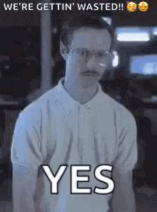 A Man With Glasses And A Mustache Is Standing In Front Of A Sign That Says Yes . GIF