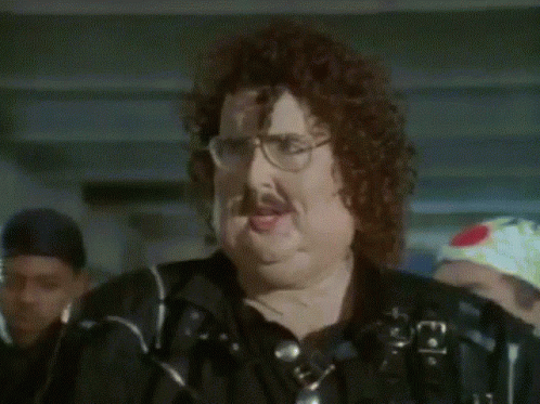 A Man With Glasses And A Mustache Is Wearing A Black Shirt GIF