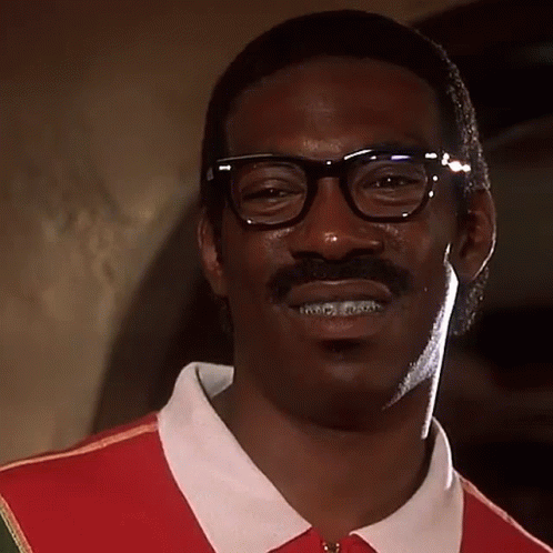 A Man With Glasses And A Mustache Is Wearing A Red Shirt And A White Shirt . GIF