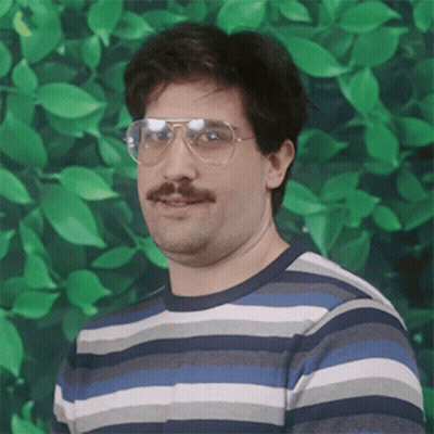 A Man With Glasses And A Mustache Is Wearing A Striped Sweater GIF