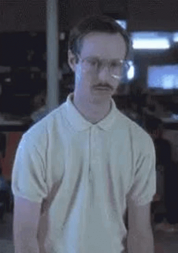 A Man With Glasses And A Mustache Is Wearing A White Shirt And A White Polo Shirt . GIF