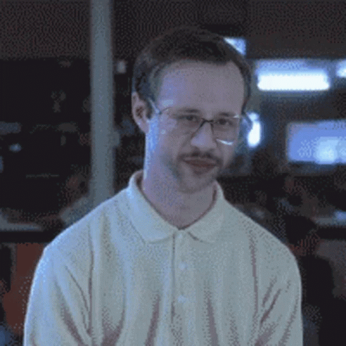 A Man With Glasses And A Mustache Is Wearing A White Sweater GIF