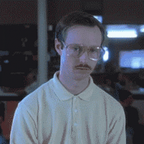 A Man With Glasses And A Mustache Is Wearing A White Sweater GIF