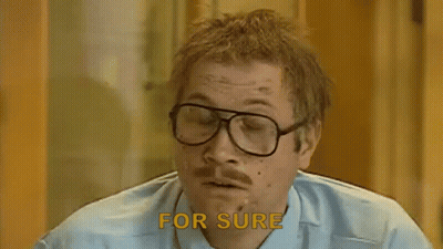 A Man With Glasses And A Mustache Says `` For Sure '' While Smoking A Cigarette . GIF