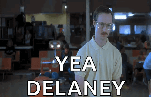 A Man With Glasses And A Mustache Says Yea Delaney In A Restaurant GIF