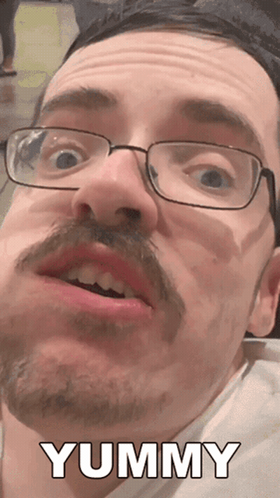 A Man With Glasses And A Mustache Says Yummy In White Letters GIF