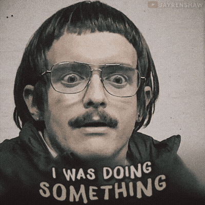A Man With Glasses And A Mustache Wears A Shirt That Says I Was Doing Something GIF
