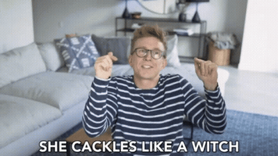 A Man With Glasses And A Striped Shirt Says She Cackle Like A Witch GIF