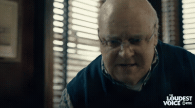 A Man With Glasses And A Sweater That Says The Loudest Voice GIF