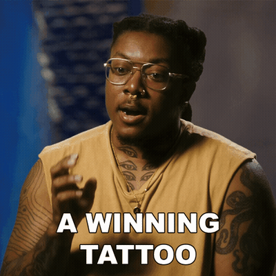A Man With Glasses And A Tattoo On His Arm Says " A Winning Tattoo " GIF