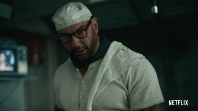 A Man With Glasses And A Towel Around His Neck Has A Netflix Logo On His Shirt GIF