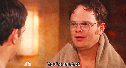 A Man With Glasses And A Towel Around His Neck Is Saying You 'Re An Idiot . GIF
