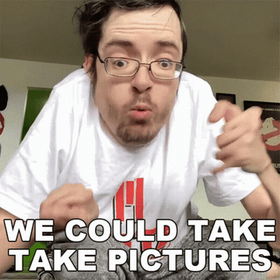 A Man With Glasses And A White Shirt That Says We Could Take Pictures On It GIF