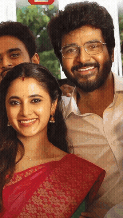 A Man With Glasses And A Woman In A Red Saree Smile For A Picture GIF