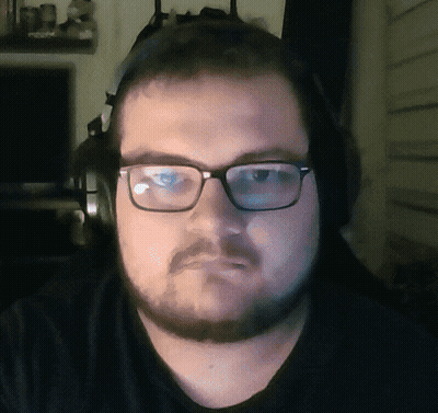 A Man With Glasses And Headphones Looks At The Camera GIF