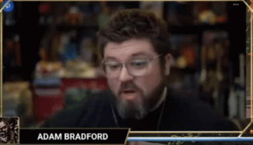 A Man With Glasses And The Name Adam Bradford On A Screen GIF