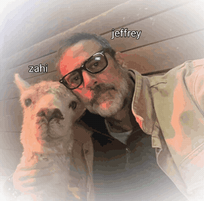A Man With Glasses Holds A Small Animal With The Name Jeffrey Written On It GIF