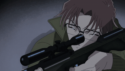 A Man With Glasses Holds A Sniper Rifle In His Hand GIF