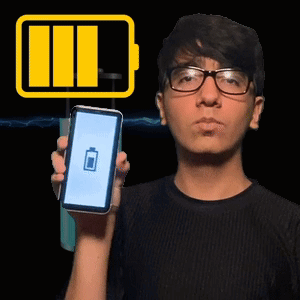 A Man With Glasses Is Holding A Cell Phone With A Battery Icon On It GIF