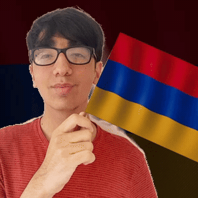 A Man With Glasses Is Holding A Small Flag GIF