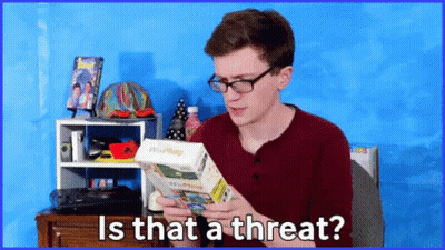 A Man With Glasses Is Holding A Wii Phone In His Hands And Asking Is That A Threat GIF