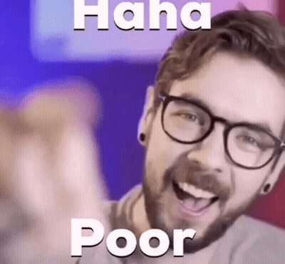 A Man With Glasses Is Laughing And Pointing At The Camera With The Words `` Haha Poor '' Above Him . GIF