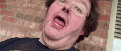 A Man With Glasses Is Making A Funny Face GIF