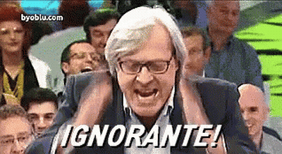 A Man With Glasses Is Screaming In Front Of A Crowd And The Words " Ignorante " Are On The Screen GIF