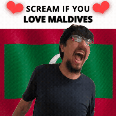 A Man With Glasses Is Screaming In Front Of A Flag That Says Scream If You Love Maldives GIF