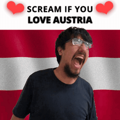 A Man With Glasses Is Screaming In Front Of An Austrian Flag GIF