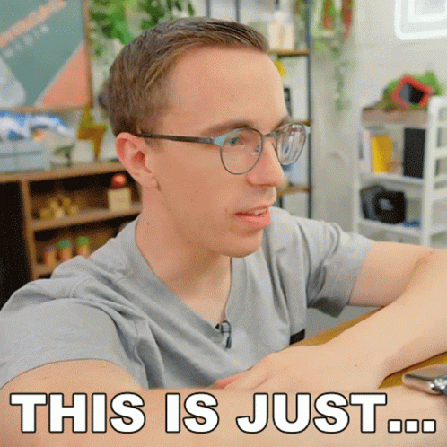 A Man With Glasses Is Sitting At A Table And Says " This Is Just " GIF