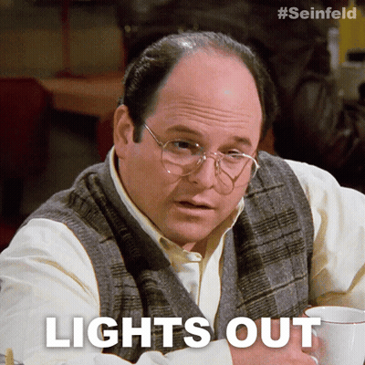 A Man With Glasses Is Sitting At A Table With A Cup Of Coffee And The Words Lights Out Above Him GIF