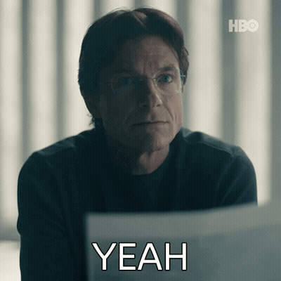 A Man With Glasses Is Sitting In Front Of A Laptop With The Word Yeah Written Below Him GIF