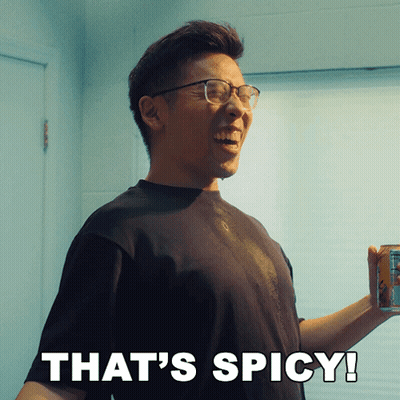 A Man With Glasses Is Smiling And Holding A Can Of Soda With The Words That 'S Spicy Below Him GIF