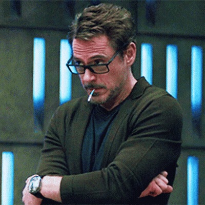 A Man With Glasses Is Smoking A Cigarette GIF
