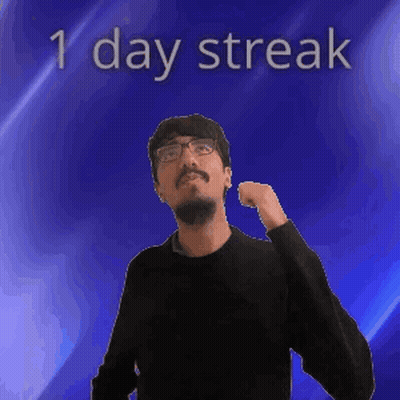 A Man With Glasses Is Standing In Front Of A Blue Background With The Words 1 Day Streak On It GIF