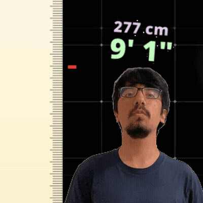 A Man With Glasses Is Standing In Front Of A Ruler That Says 277 Cm 9 1 " GIF