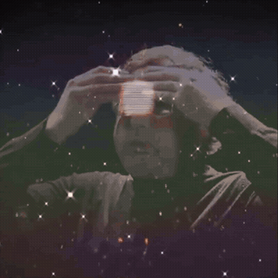 A Man With Glasses Is Surrounded By A Light Circle GIF