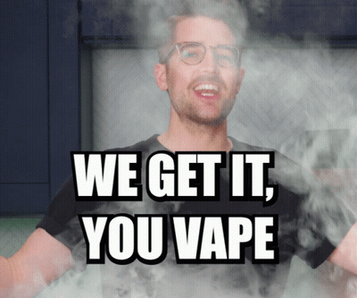 A Man With Glasses Is Surrounded By Smoke And The Words We Get It You Vape GIF