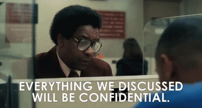 A Man With Glasses Looks At Himself In A Mirror With The Words Everything We Discussed Will Be Confidential Below Him GIF