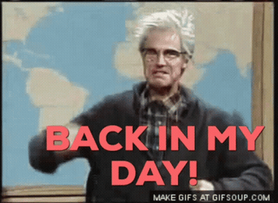 A Man With Glasses Says Back In My Day In Red Letters GIF