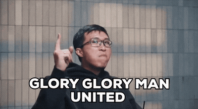 A Man With Glasses Says Glory Glory Man United With His Finger Up GIF