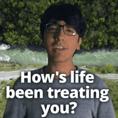 A Man With Glasses Says How 'S Life Been Treating You In Front Of A River GIF