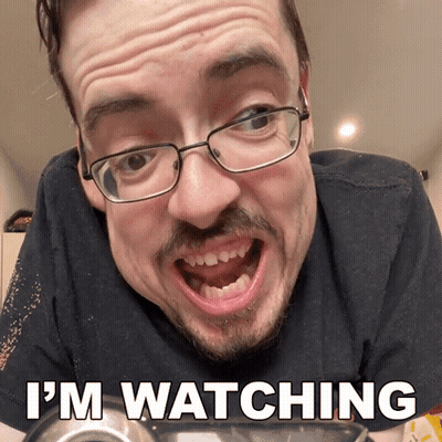 A Man With Glasses Says I 'M Watching With His Mouth Open GIF