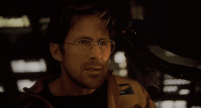 A Man With Glasses Says " They Think I 'M Dumb " In A Dark Room GIF